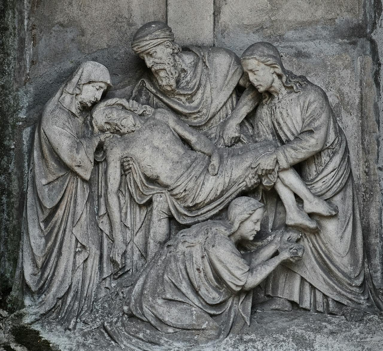 Intricate stone relief depicting a religious scene with figures. Ideal for historical art.